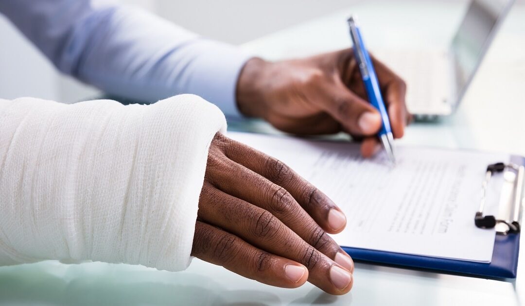 Injured person writing on the form