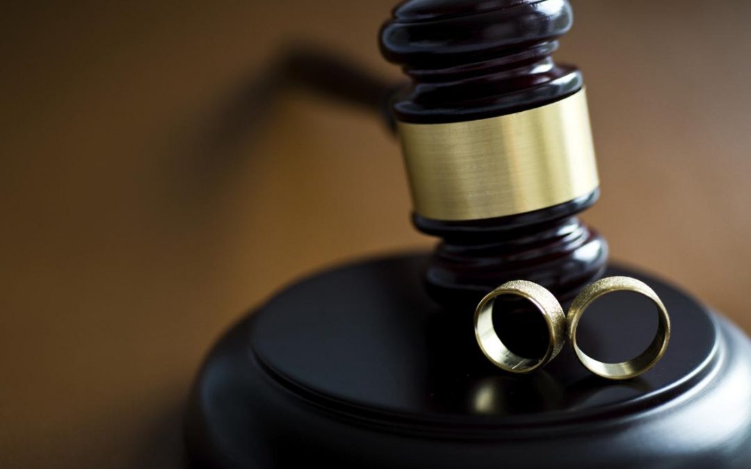 Gavel and wedding rings on block