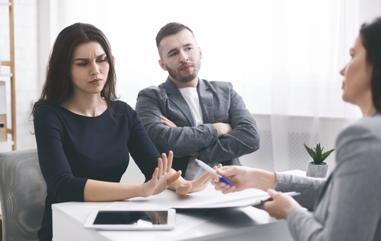 woman refusing to sign documents in a professional's office